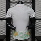 Mannequin wearing a white sports jersey with floral shorts against a black metal grid background