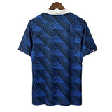Blue patterned shirt on a hanger against a gray background
