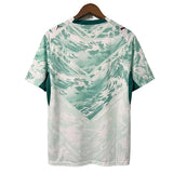 Green and white patterned shirt on a hanger against a gray background