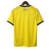 Yellow sports jersey with blue and red accents on a gray background