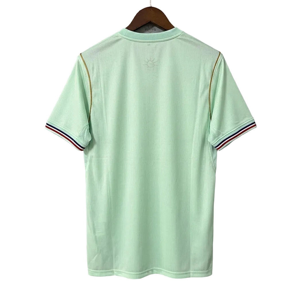 Light green polo shirt on a hanger against a gray background