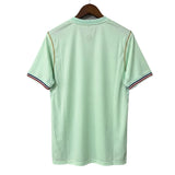 Light green polo shirt on a hanger against a gray background