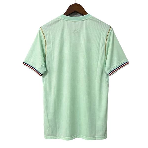 Light green polo shirt on a hanger against a gray background