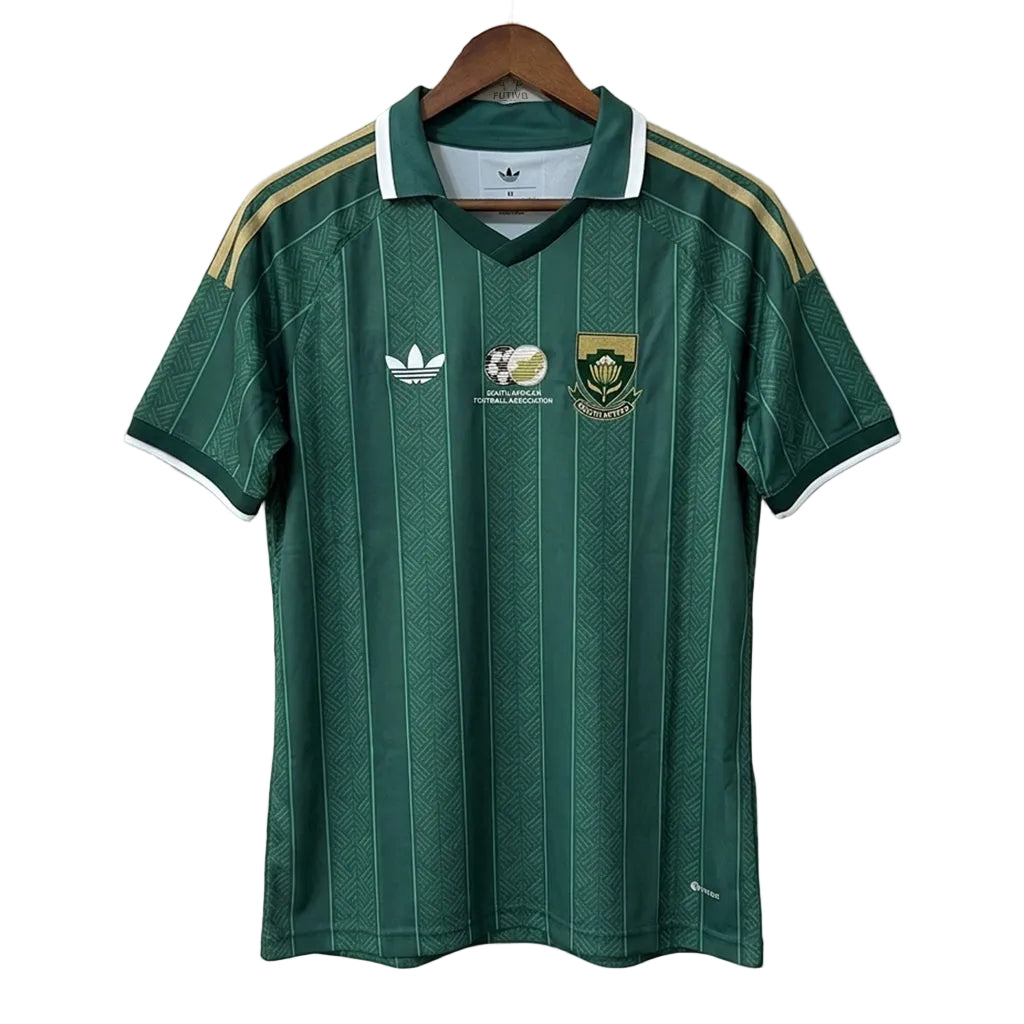 Green sports jersey with Adidas logo on a hanger against a plain background