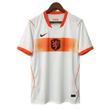 White sports jersey with orange accents on a hanger against a gray background
