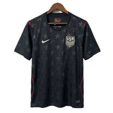 Black sports jersey with star pattern and USA logo on a hanger against a white background