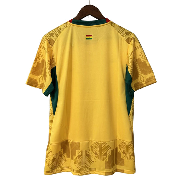 Yellow sports jersey with green accents on a hanger against a gray background