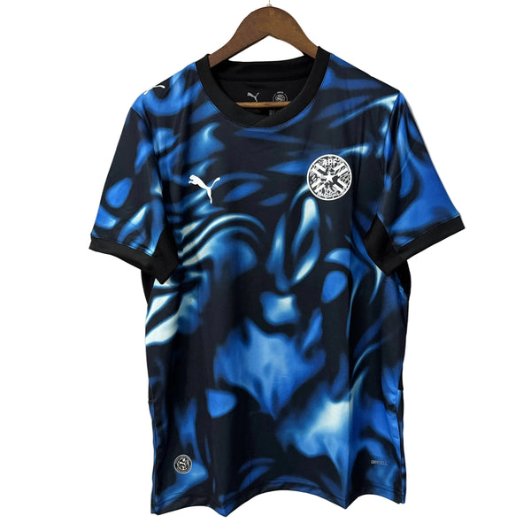 Blue and black sports jersey with a logo on a hanger against a gray background