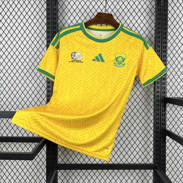 Yellow sports jersey with green accents on a hanger against a metal grid background
