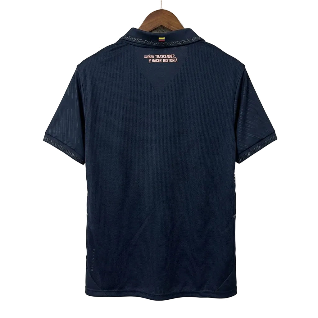 Navy blue polo shirt on a hanger against a white wall