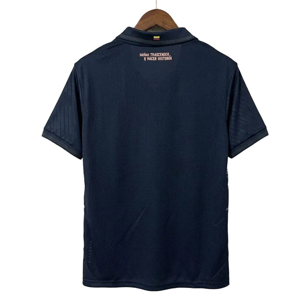 Navy blue polo shirt on a hanger against a white wall