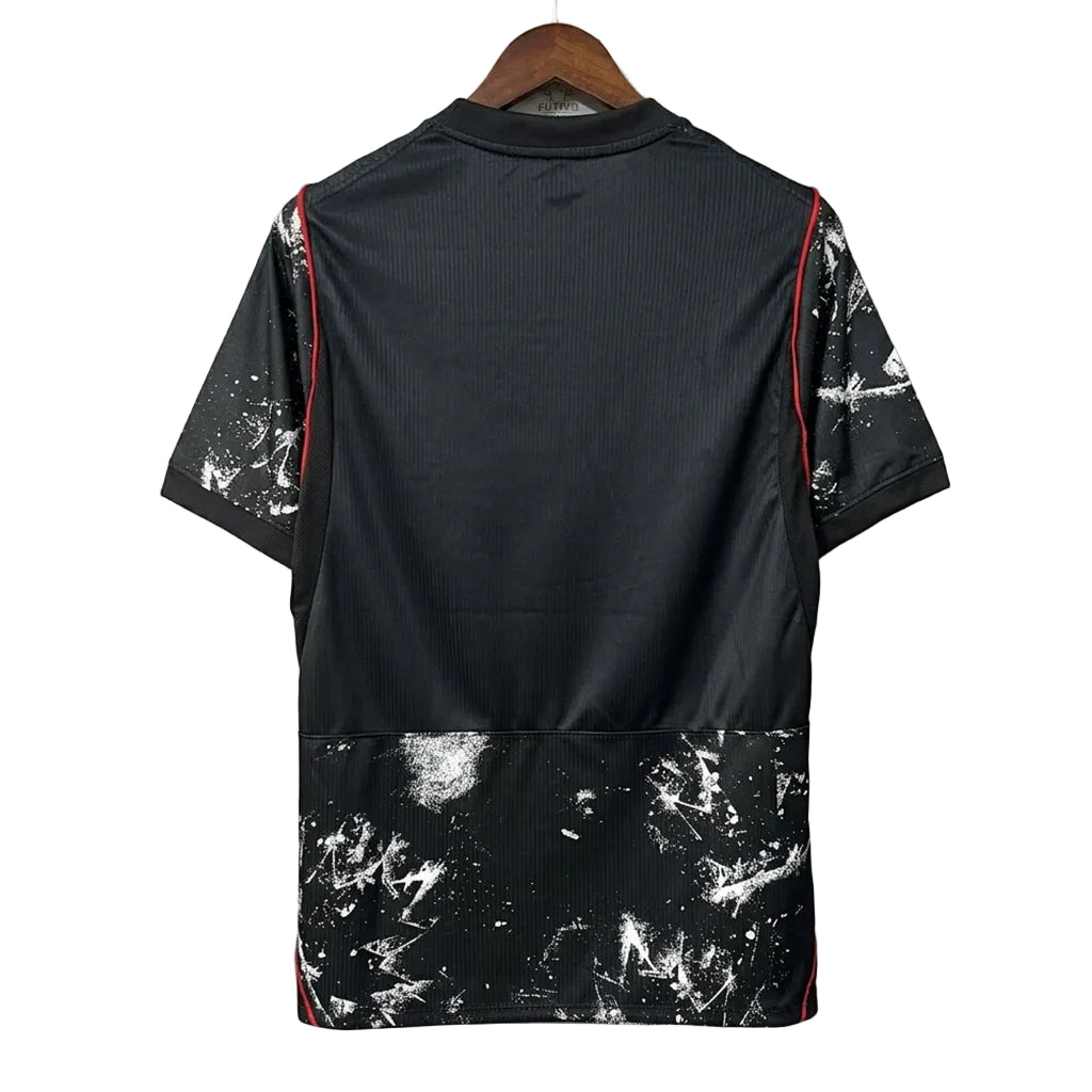 Black shirt with white abstract pattern on a hanger against a gray background