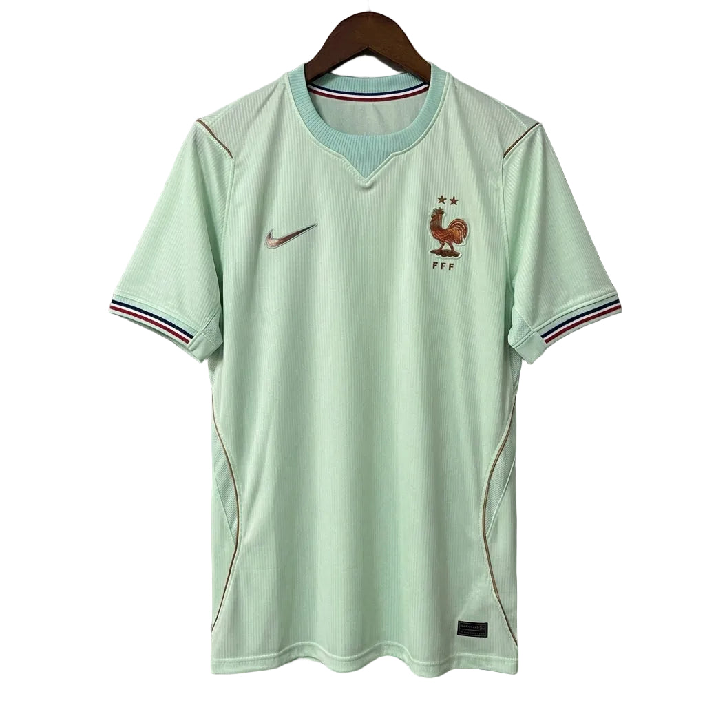 Light green sports jersey with brand logo on a hanger against a gray background