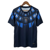Navy blue sports jersey with blue patterns on a hanger against a light gray background